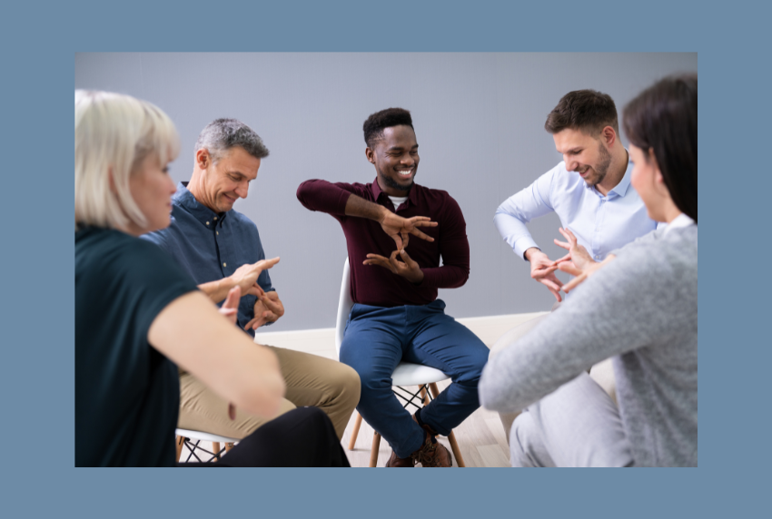 Group of people learning sign language. 