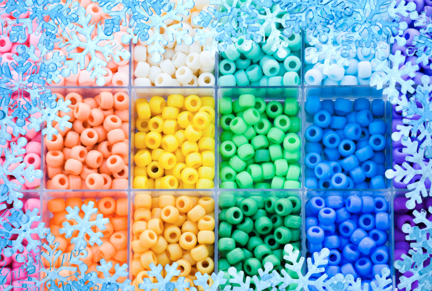 colored pony beads in a bin with a snowflake frame